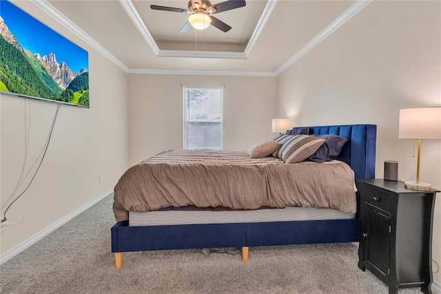 carpeted bedroom featuring a raised ceiling, ceiling fan, and crown molding