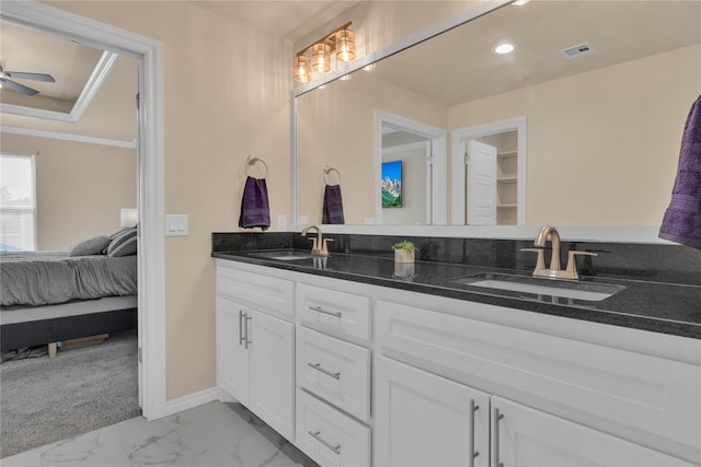 bathroom featuring ceiling fan, crown molding, and vanity