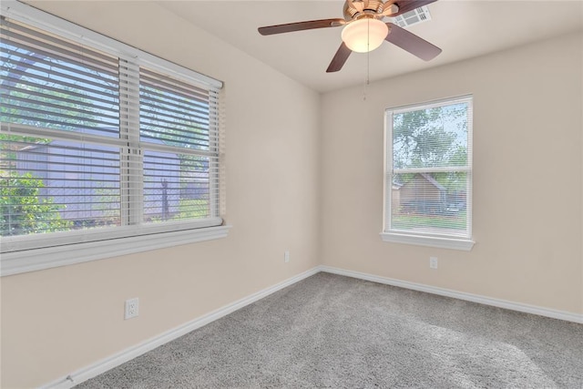 unfurnished room featuring ceiling fan, plenty of natural light, and carpet floors