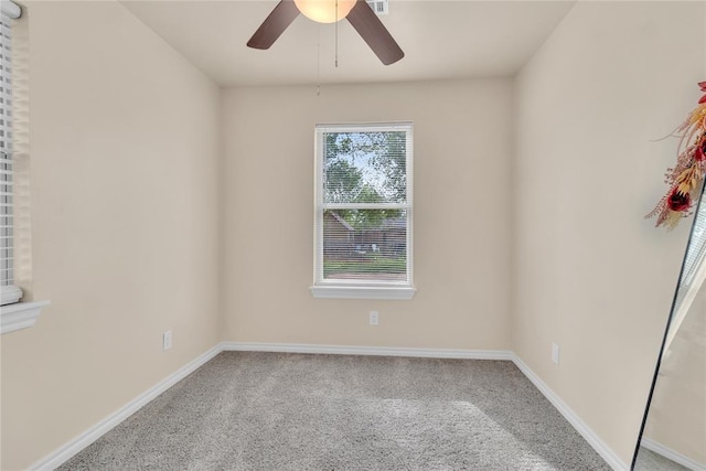 carpeted spare room with ceiling fan