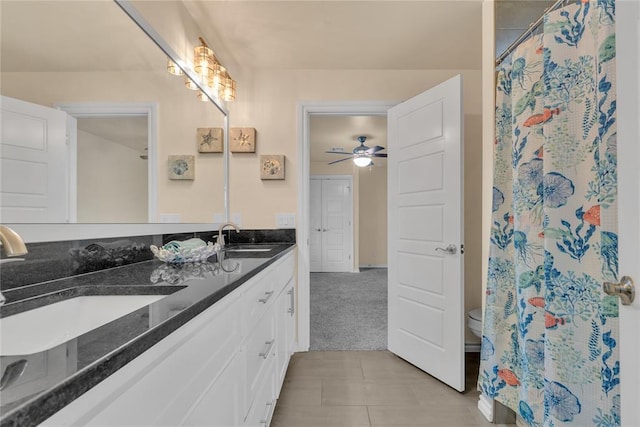 bathroom featuring curtained shower, ceiling fan, tile patterned flooring, toilet, and vanity