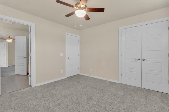 unfurnished bedroom with carpet floors, a closet, and ceiling fan