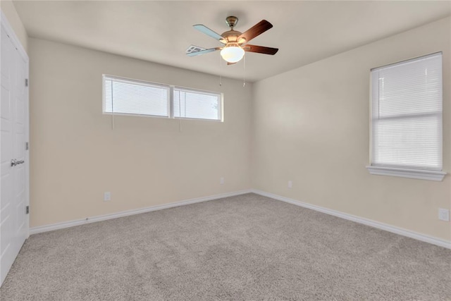 carpeted empty room featuring ceiling fan