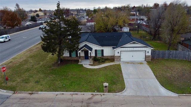 view of front of home featuring a front lawn and a garage