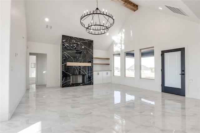 unfurnished living room featuring a notable chandelier, beam ceiling, and high vaulted ceiling