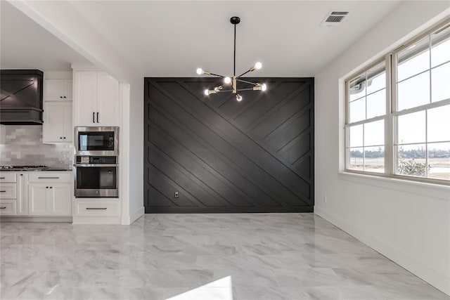 kitchen featuring white cabinets, plenty of natural light, and appliances with stainless steel finishes