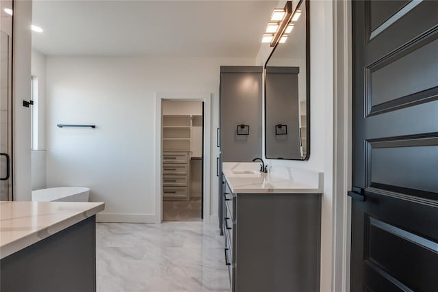 bathroom with vanity and a shower with door