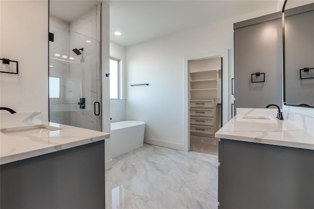 bathroom with vanity and shower with separate bathtub