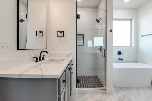 bathroom with separate shower and tub and vanity