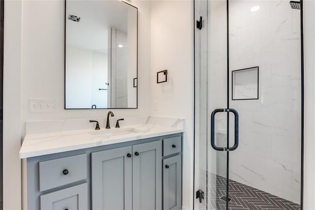 bathroom featuring vanity and a shower with shower door