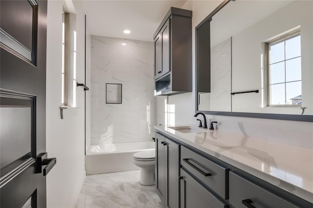 full bathroom with vanity, toilet, and tiled shower / bath combo