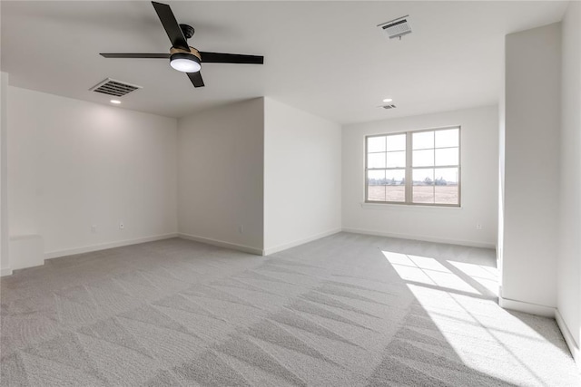 unfurnished room with light carpet and ceiling fan