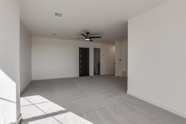 empty room with ceiling fan and light colored carpet