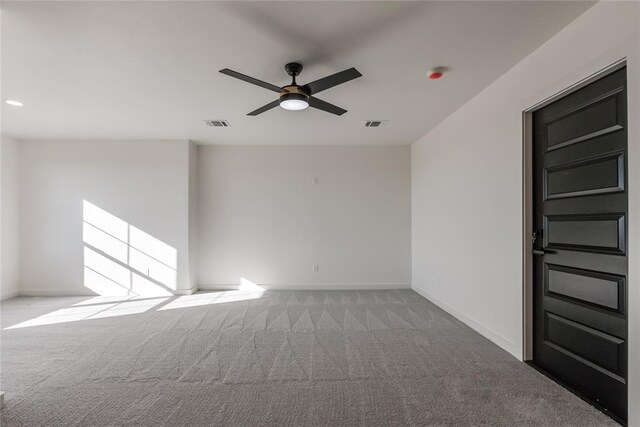 empty room with ceiling fan and light colored carpet