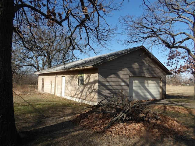 view of property exterior featuring a garage and an outdoor structure