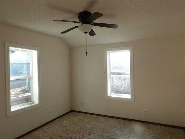 empty room with light carpet, a textured ceiling, ceiling fan, and lofted ceiling