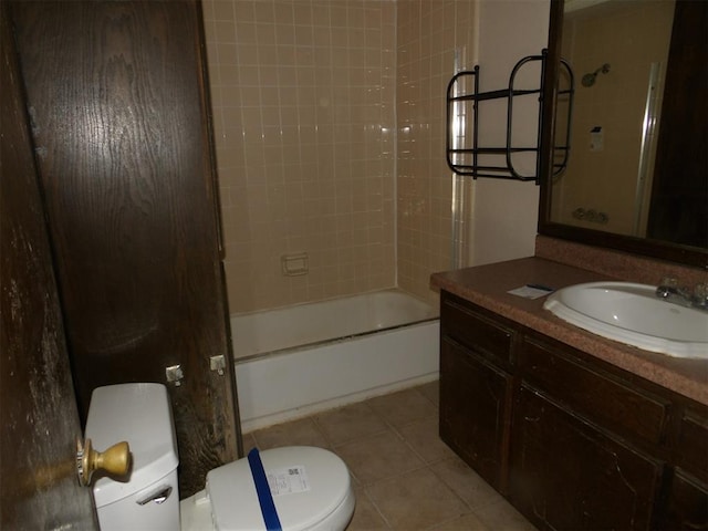 full bathroom featuring tile patterned floors, vanity, tiled shower / bath combo, and toilet