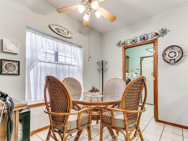 dining area with ceiling fan, light tile patterned floors, and washer / dryer