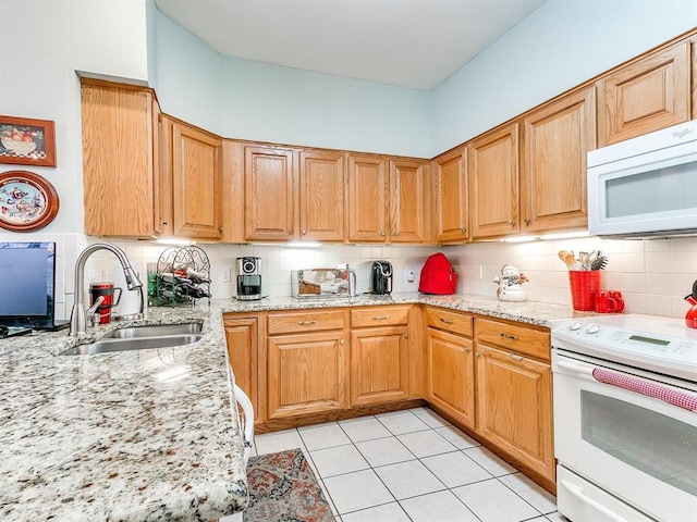 kitchen featuring white appliances, sink, light tile patterned floors, tasteful backsplash, and light stone counters