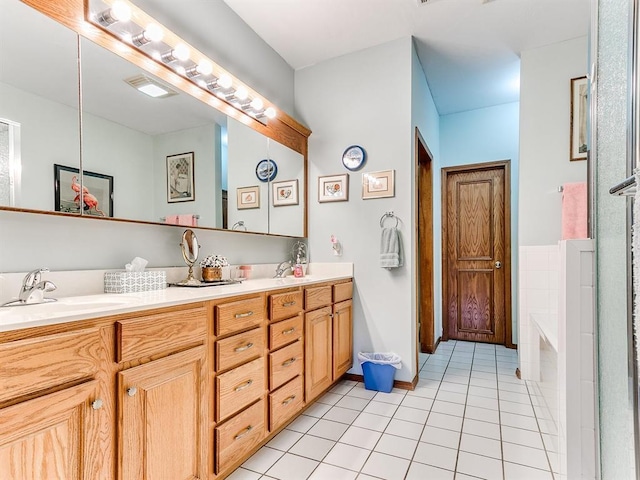 bathroom featuring a tub to relax in, tile patterned flooring, and vanity