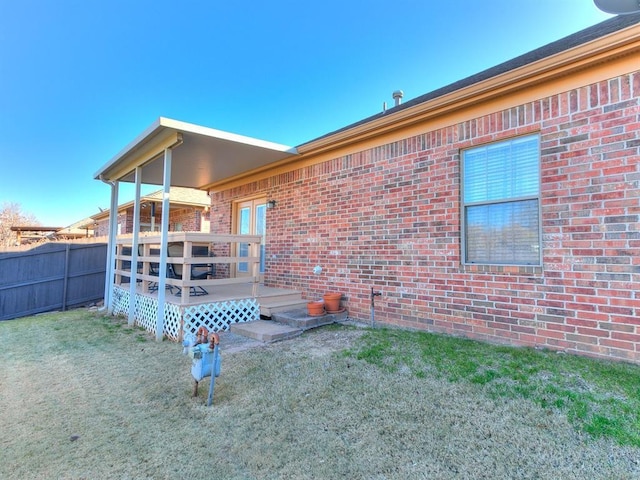 back of house featuring a yard and a deck