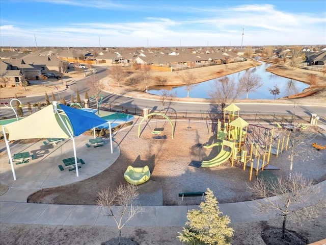 exterior space featuring a playground and a water view