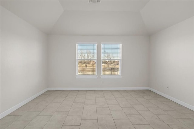 spare room with vaulted ceiling