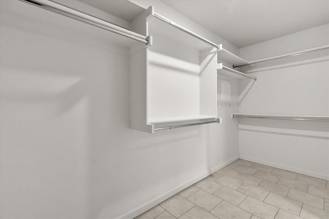 spacious closet featuring light tile patterned floors