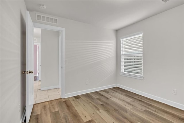 spare room featuring light wood-type flooring