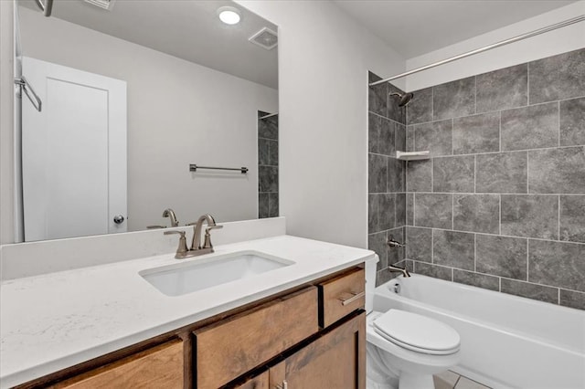 full bathroom featuring tiled shower / bath combo, vanity, and toilet