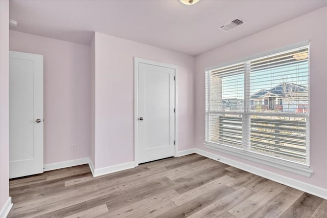 unfurnished room with light hardwood / wood-style floors