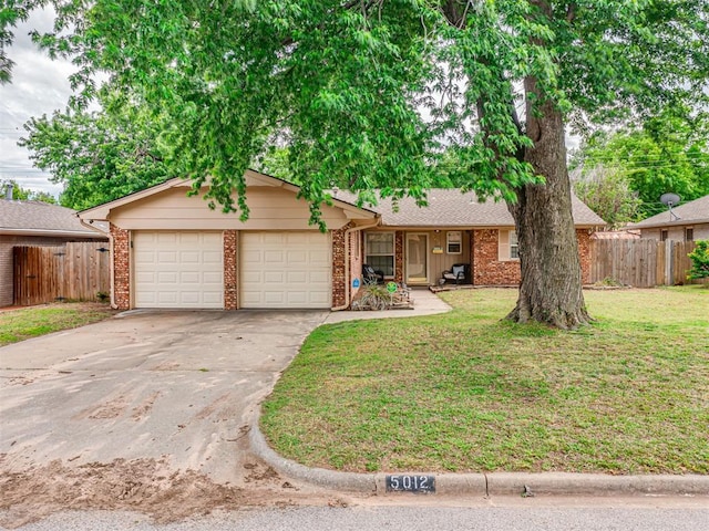 ranch-style home with a garage and a front lawn