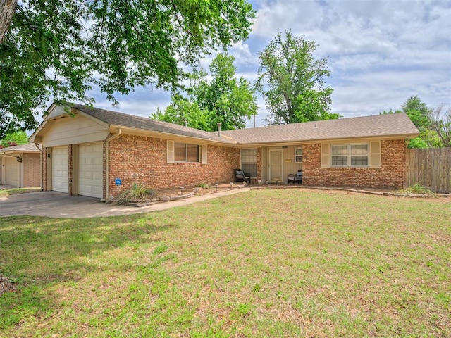 ranch-style home with a front lawn and a garage