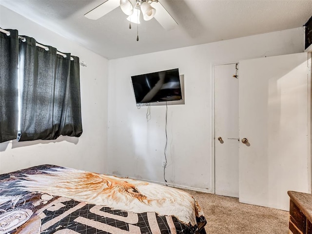 bedroom with ceiling fan and light colored carpet