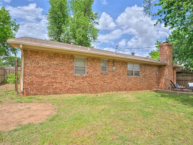 rear view of house with a yard