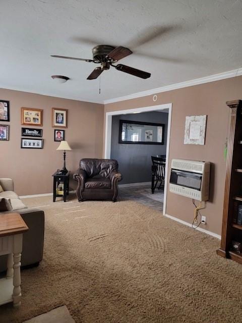 carpeted living room featuring ceiling fan, ornamental molding, and heating unit