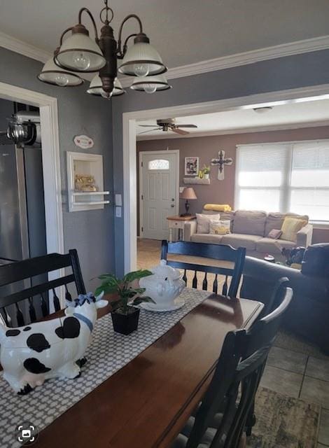 tiled dining area featuring crown molding and ceiling fan with notable chandelier