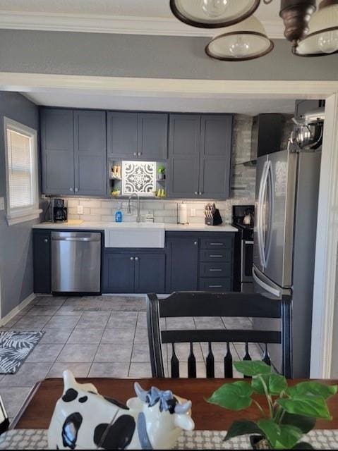 kitchen featuring sink, tasteful backsplash, appliances with stainless steel finishes, light tile patterned flooring, and ornamental molding