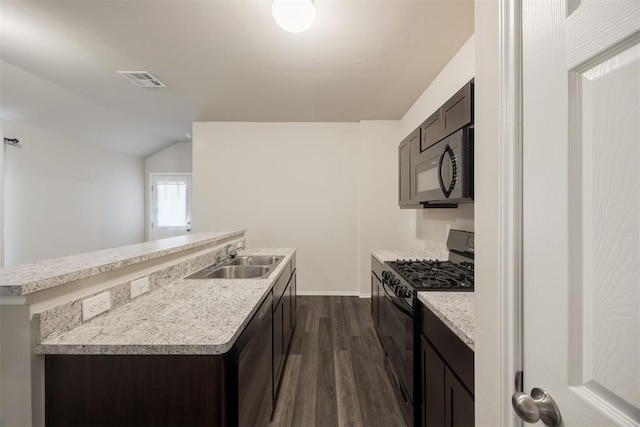 kitchen featuring black appliances, sink, vaulted ceiling, dark hardwood / wood-style floors, and dark brown cabinets