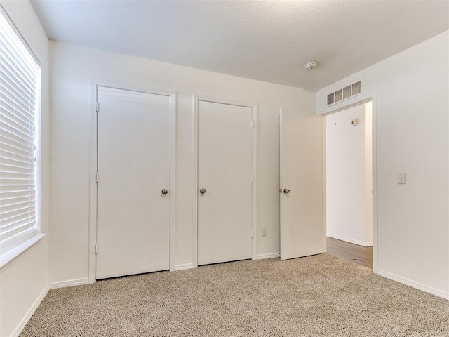 unfurnished bedroom featuring carpet flooring