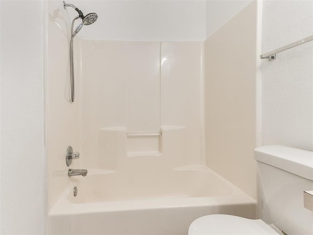 bathroom with toilet and bathing tub / shower combination