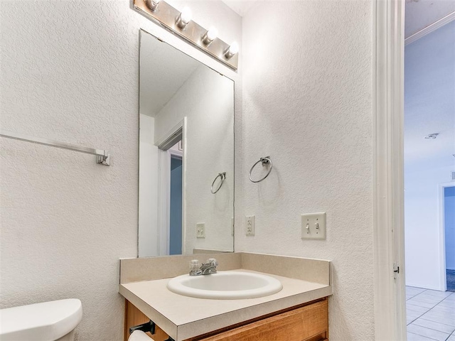 bathroom featuring tile patterned floors, vanity, and toilet