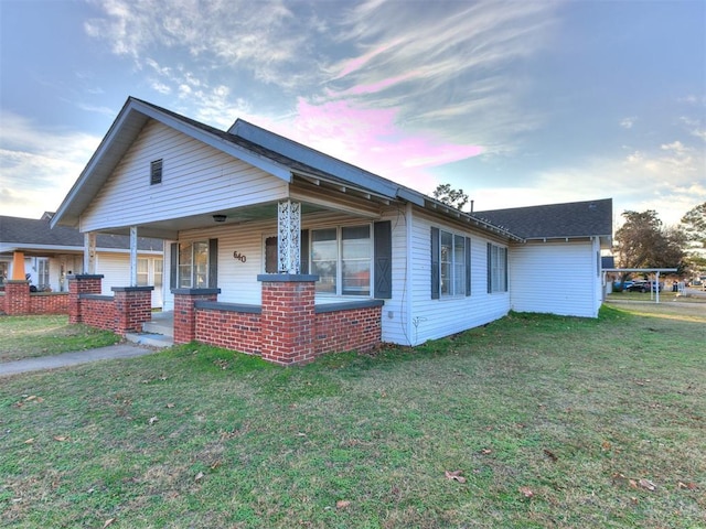 view of front of house featuring a yard and covered porch