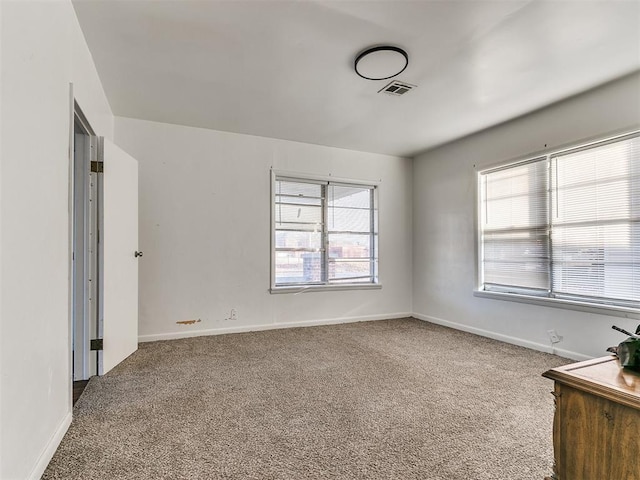 unfurnished bedroom with multiple windows and carpet floors