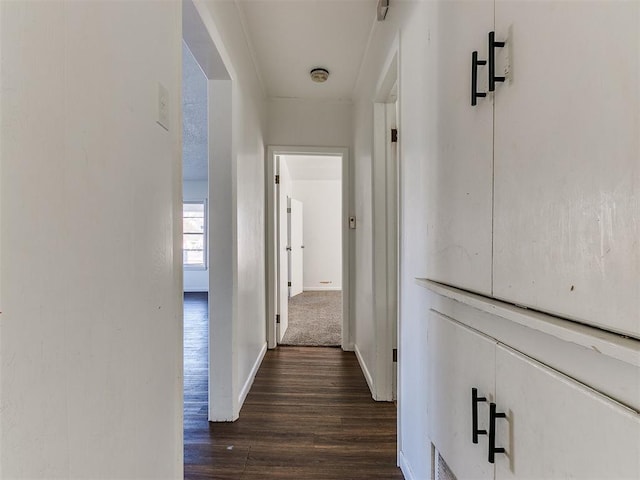 corridor featuring dark wood-type flooring