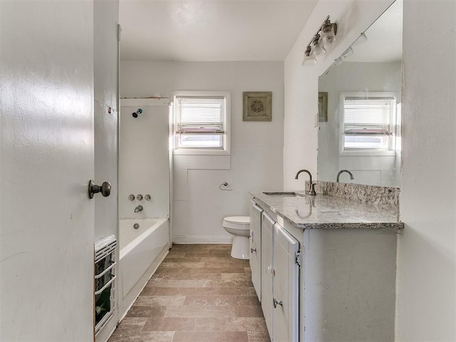 full bathroom with hardwood / wood-style floors, vanity, a healthy amount of sunlight, and toilet