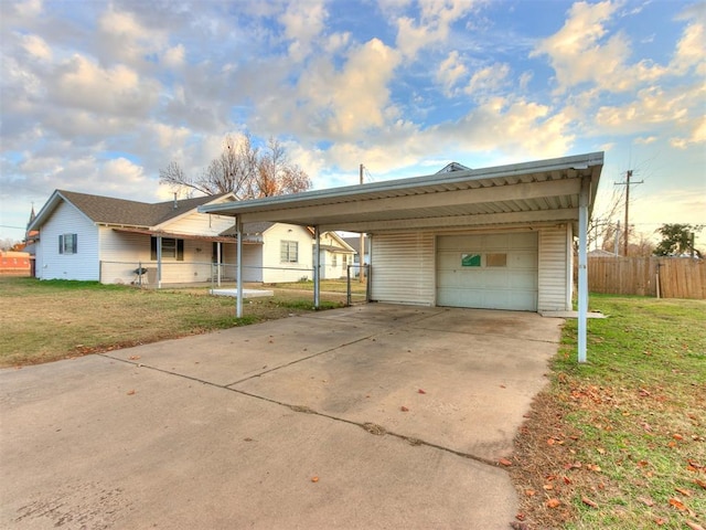 ranch-style home featuring a front lawn, a garage, and a carport