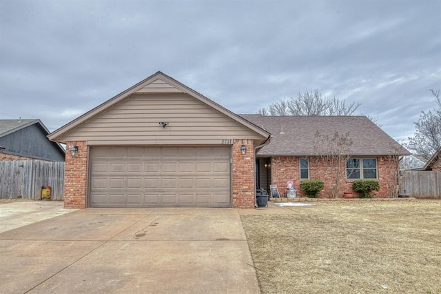 single story home with concrete driveway, brick siding, and fence