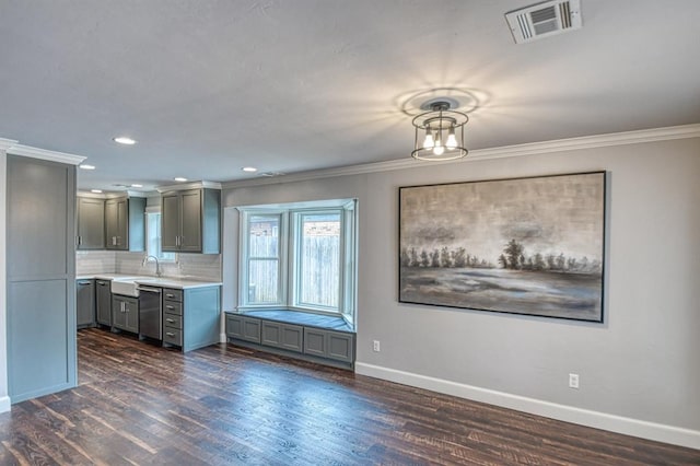 kitchen with baseboards, dark wood finished floors, visible vents, light countertops, and stainless steel dishwasher