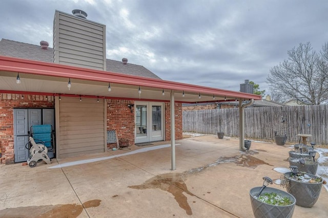 view of patio / terrace featuring french doors and fence